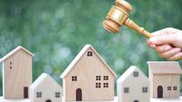 Property auction, Woman hand holding gavel wooden and model house on natural green background, lawyer of home real estate and ow