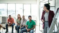 Mid adult woman doing a presentation during a meeting