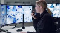 Watch, security and woman with radio, cctv and monitor for danger, talking and control room for guard. Desk, night and working f